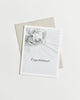Greeting card with a black and white photo of baby feet and “Congratulations!” in cursive.