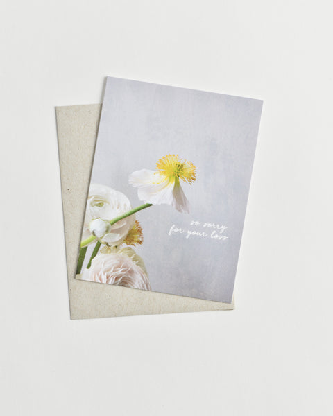 Photo greeting card of a white and yellow flower and words “so sorry for your loss” in cursive.
