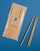 Package of 12 tall hand-dipped beeswax birthday candles in a natural pale yellow color.