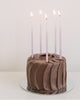 Package of 12 tall hand-dipped violet color beeswax birthday candles with ombré effect