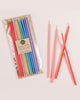 Package of 12 tall hand-dipped beeswax birthday candles in assorted rainbow colors.